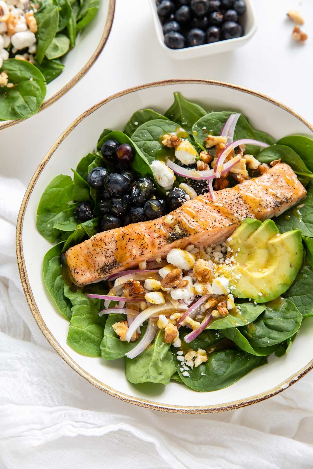 salmon salad with spinach, avocado, red onion, walnuts and goat cheese