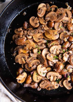 Sauteed mushrooms in a cast iron skillet.