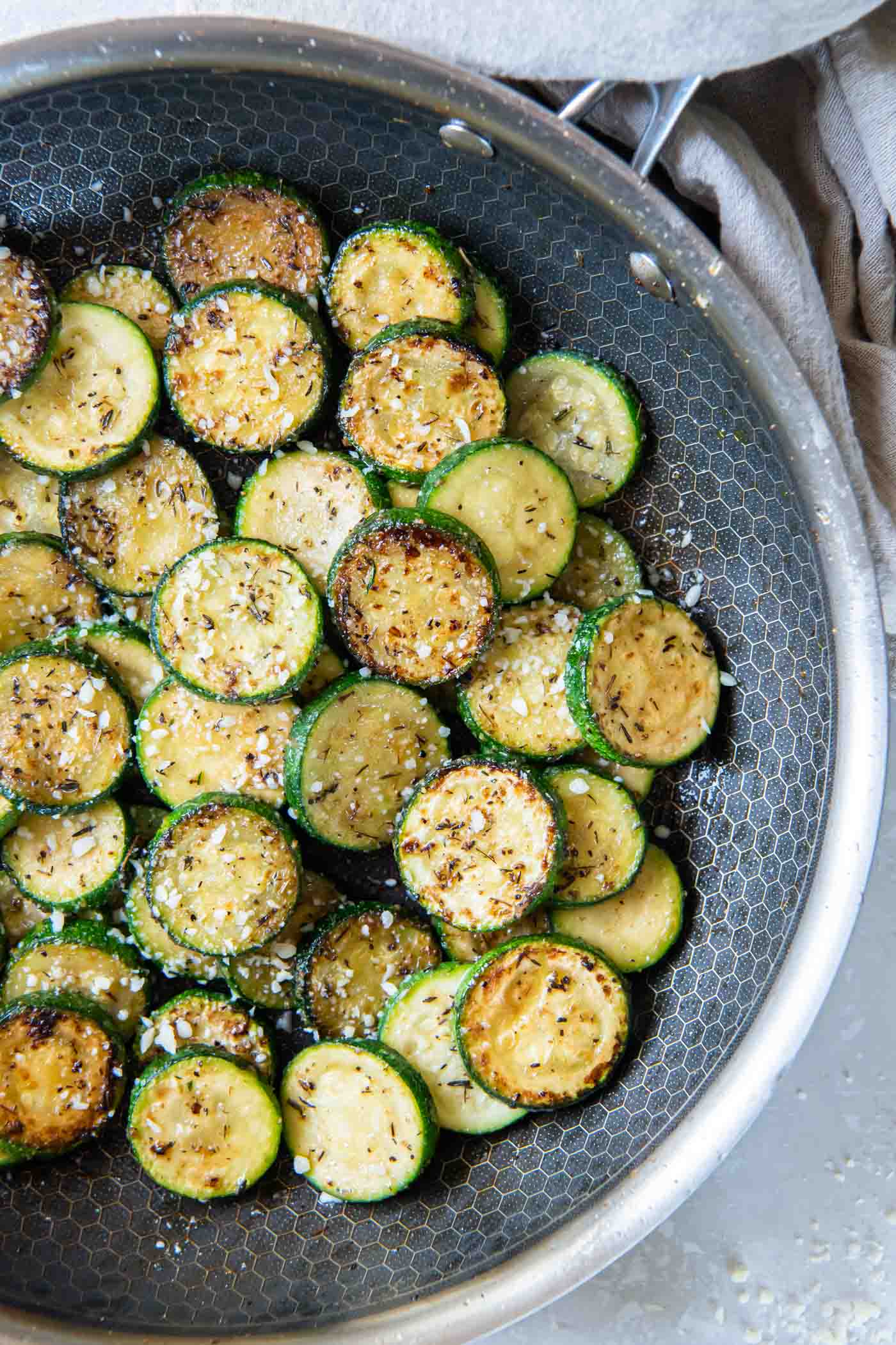 Sauteed zucchini in a skillet.