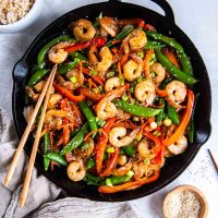 Shrimp and vegetable stir fry in a skillet.