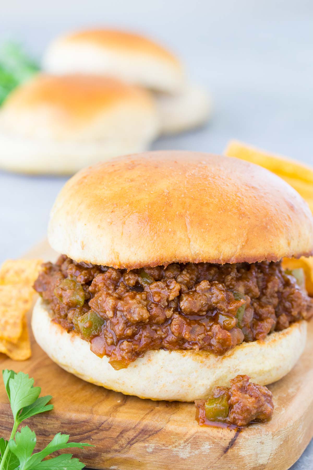 Sloppy Joe sandwich on wood board.