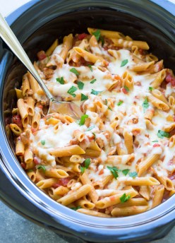 This Slow Cooker Baked Ziti is made with ground turkey and whole wheat pasta. The pasta cooks right in your crock pot so it soaks up the delicious flavor of the sauce. This healthier slow cooker pasta recipe is a simple comfort food dinner for your family!