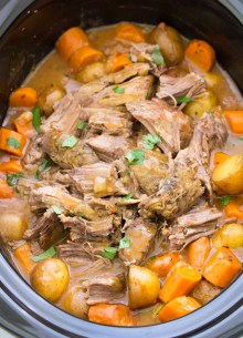 Pot roast with potatoes and carrots in a slow cooker.