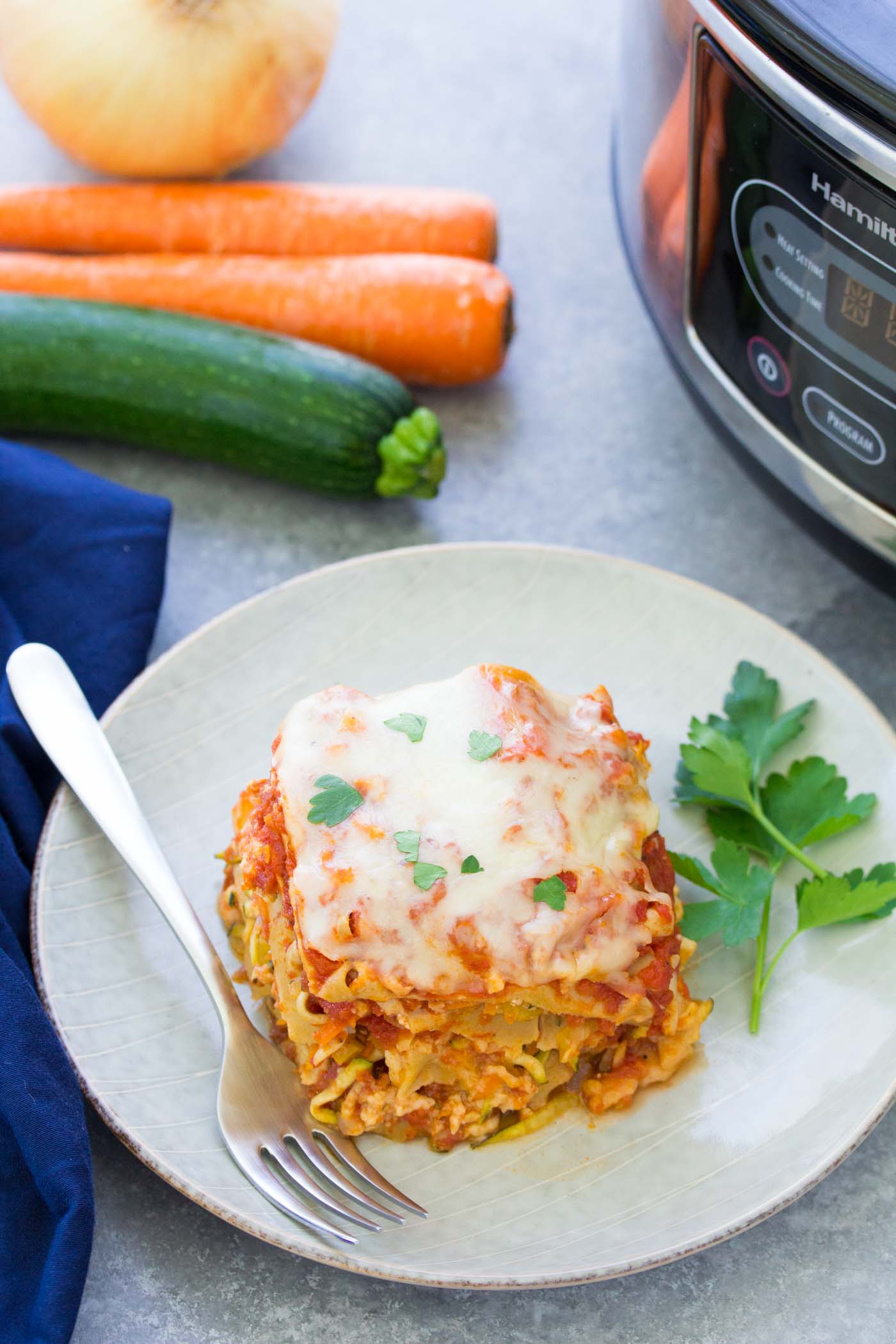 Slice of slow cooker turkey lasagna on a plate with a fork.