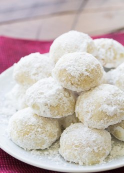 snowball cookies stacked on a plate