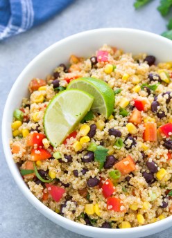 Southwest quinoa salad in a serving bowl with lime wedges.