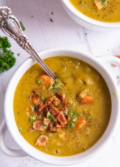 Split pea soup with bacon in a white bowl.