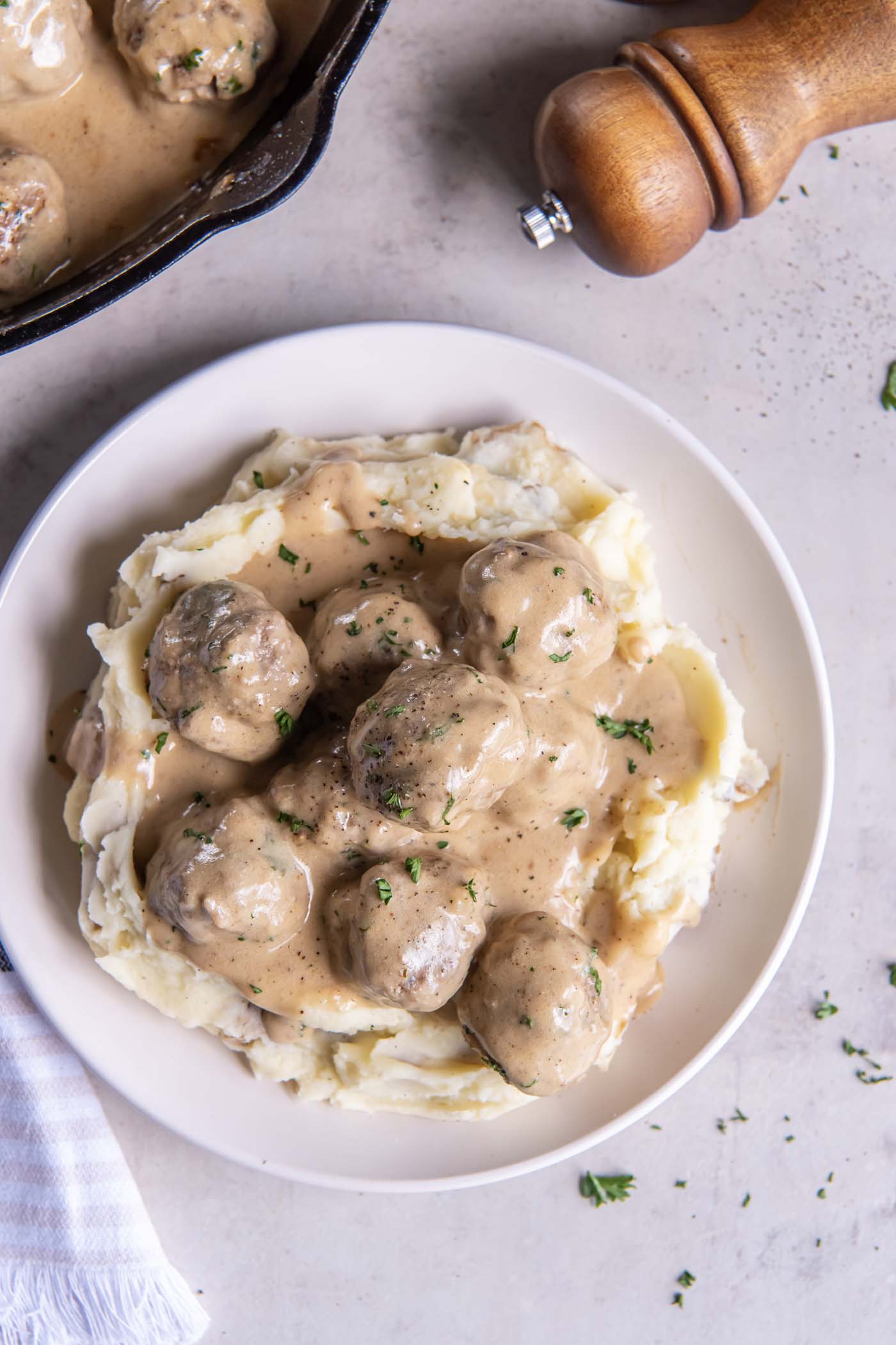 Meatballs and gravy served over mashed potatoes.