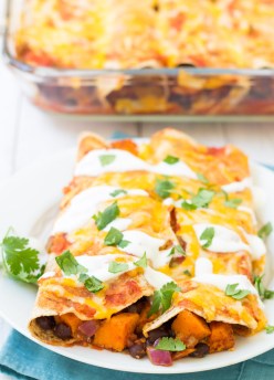 Vegetarian enchiladas with sweet potato and black beans on a plate.