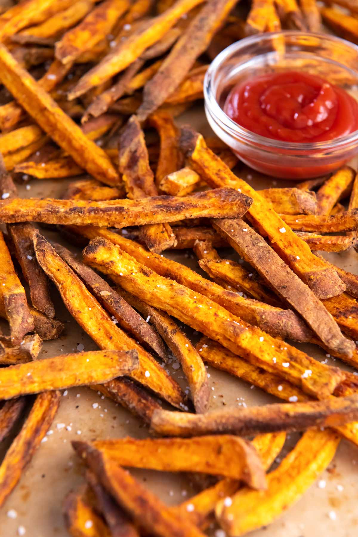 Baked sweet potato fries served with ketchup.