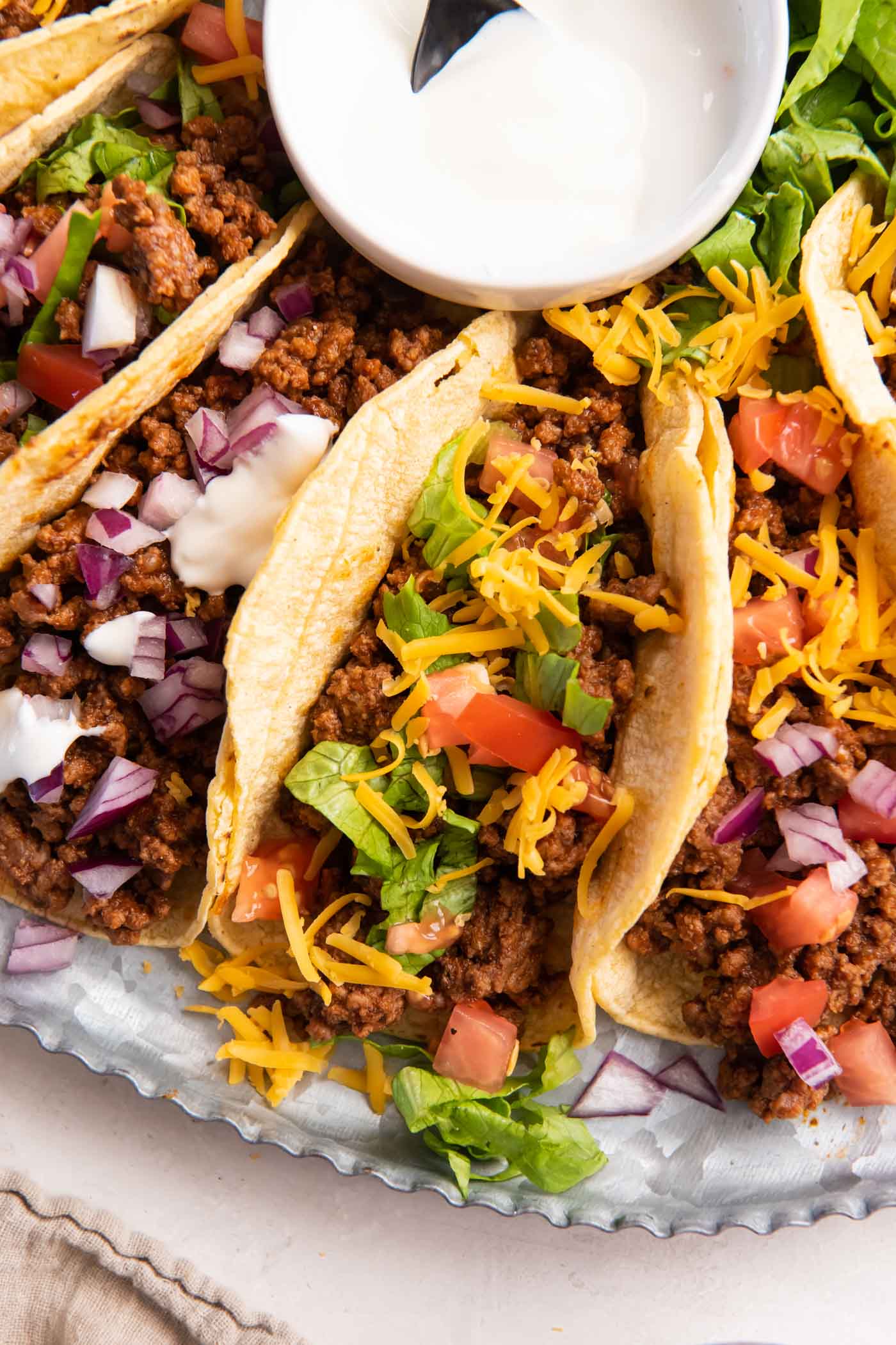 Ground beef tacos with a variety of toppings.