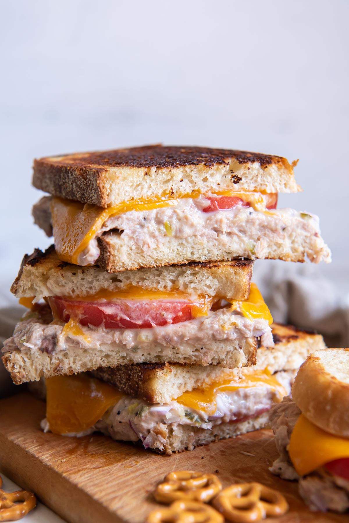 Three tuna melt sandwich halves stacked on top of each other.