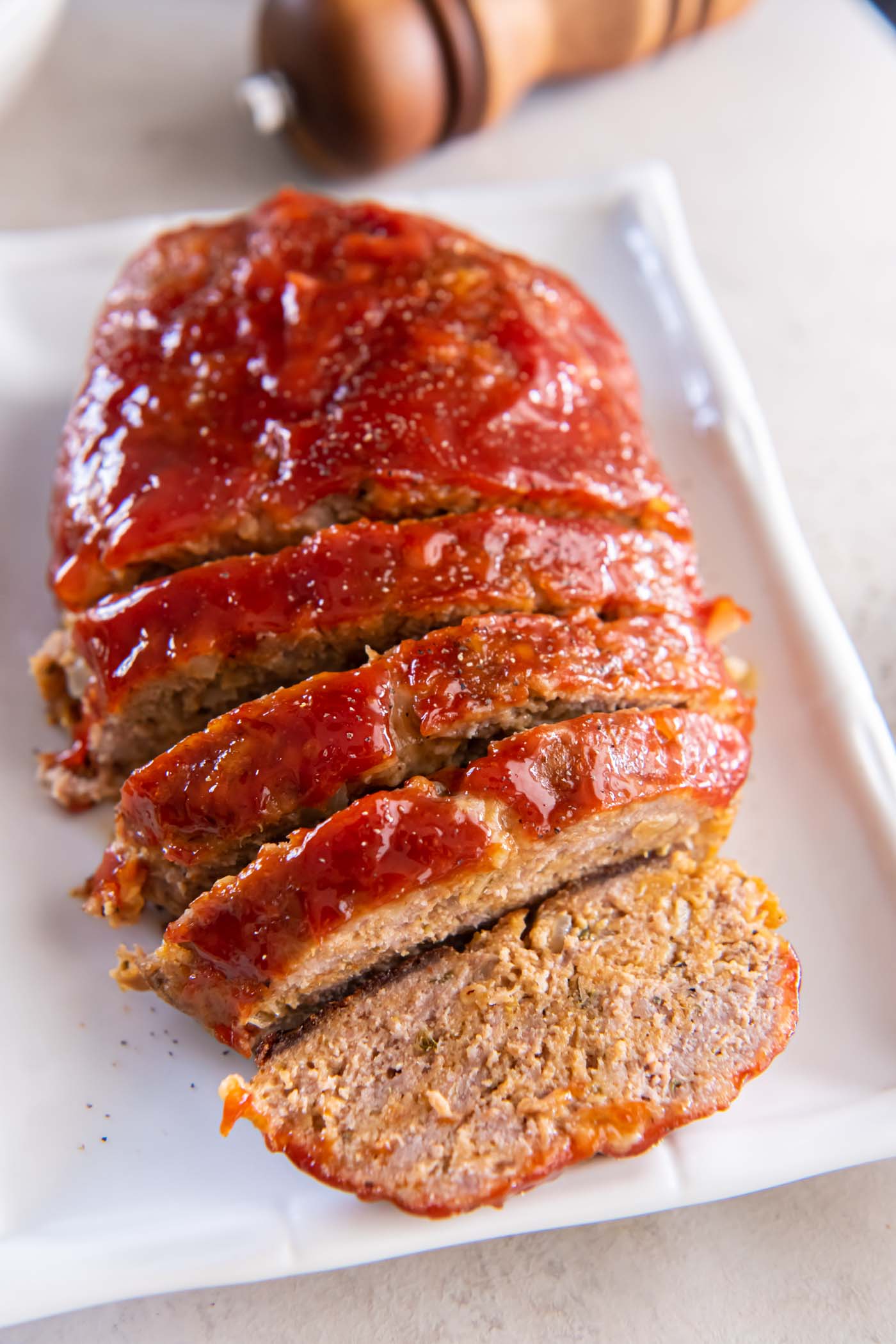 Partially sliced turkey meatloaf on a serving platter.