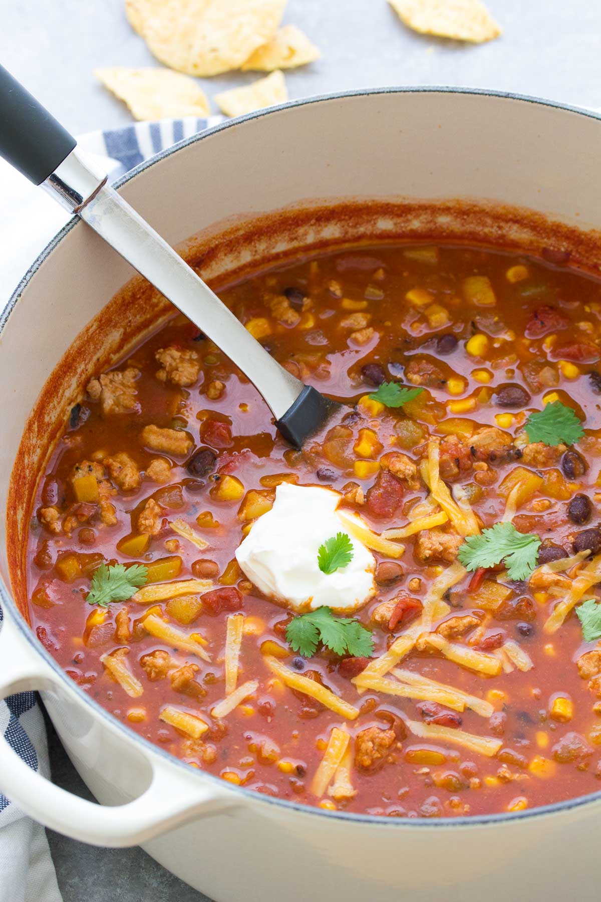 turkey taco soup in a dutch oven pot with a serving spoon