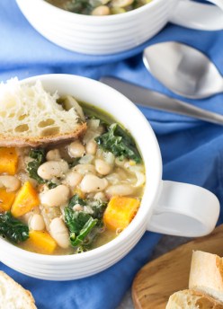 This healthy 30 Minute Tuscan White Bean and Kale Soup is vegetarian, vegan, and so easy to make! It's a warm and comforting dinner that reheats wonderfully for lunch!