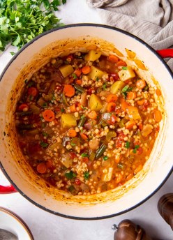 Vegetable barley soup in a Dutch oven pot.