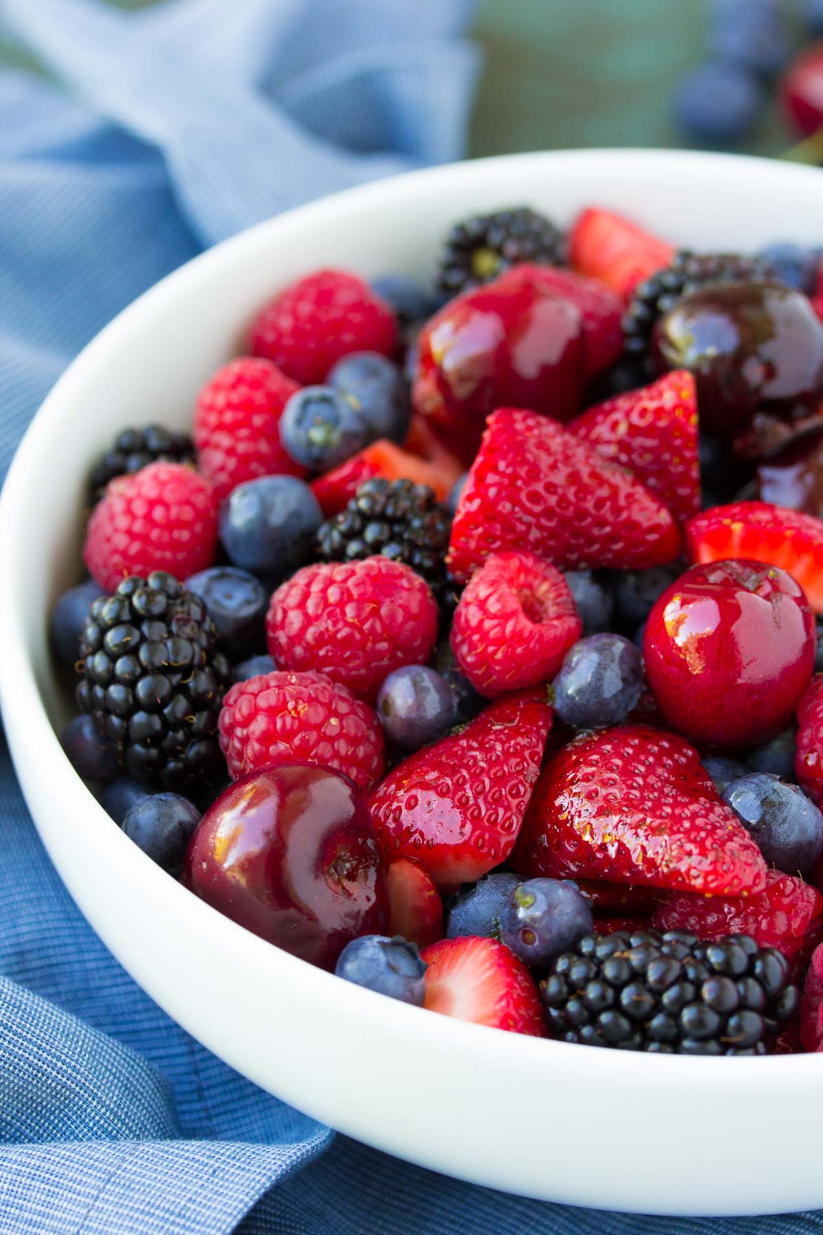 Berry fruit salad in white bowl.