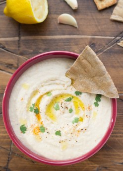 Easy white bean dip made with olive oil, lemon juice and garlic. Served in a bowl with pita bread.