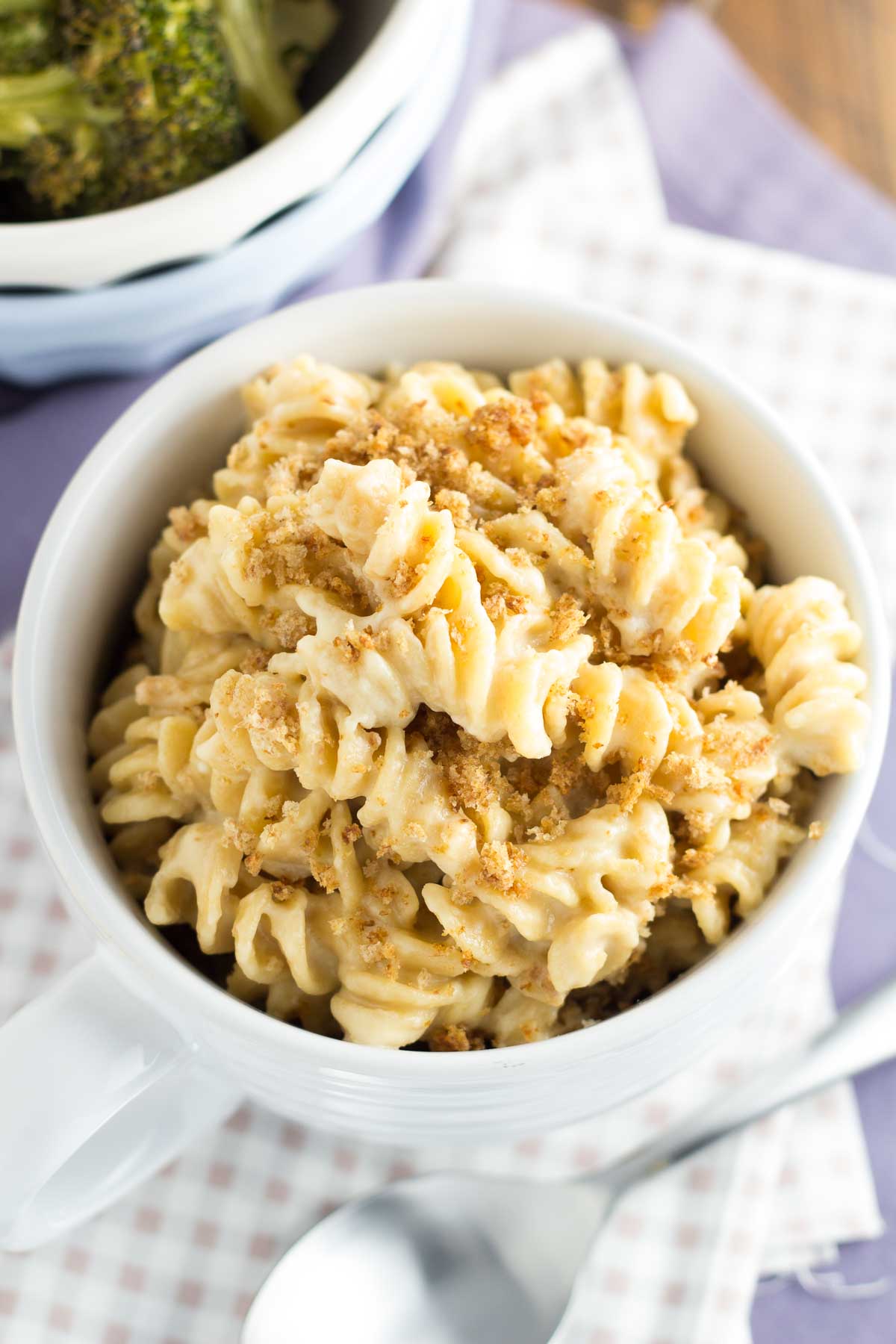 Whole wheat mac and cheese with crumb topping served in a bowl.